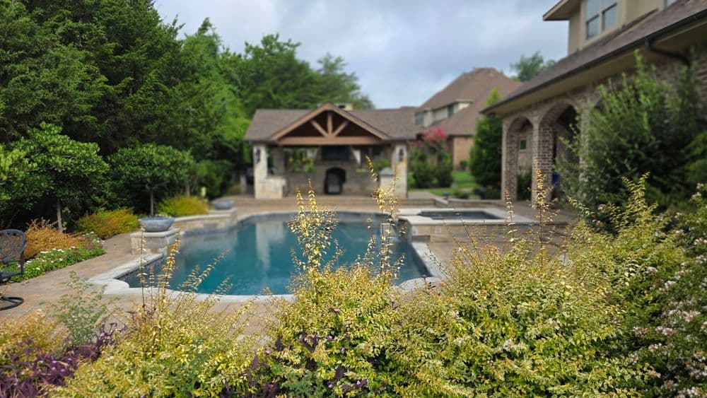 Luxury backyard oasis with a pool, gazebo, and lush landscaping. Perfect for relaxation.